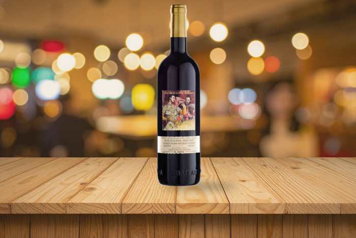 Bottle of Château Ksara Cuvée du Troisième Millénaire 2018 on a dining table with wine glass and warm ambient lighting