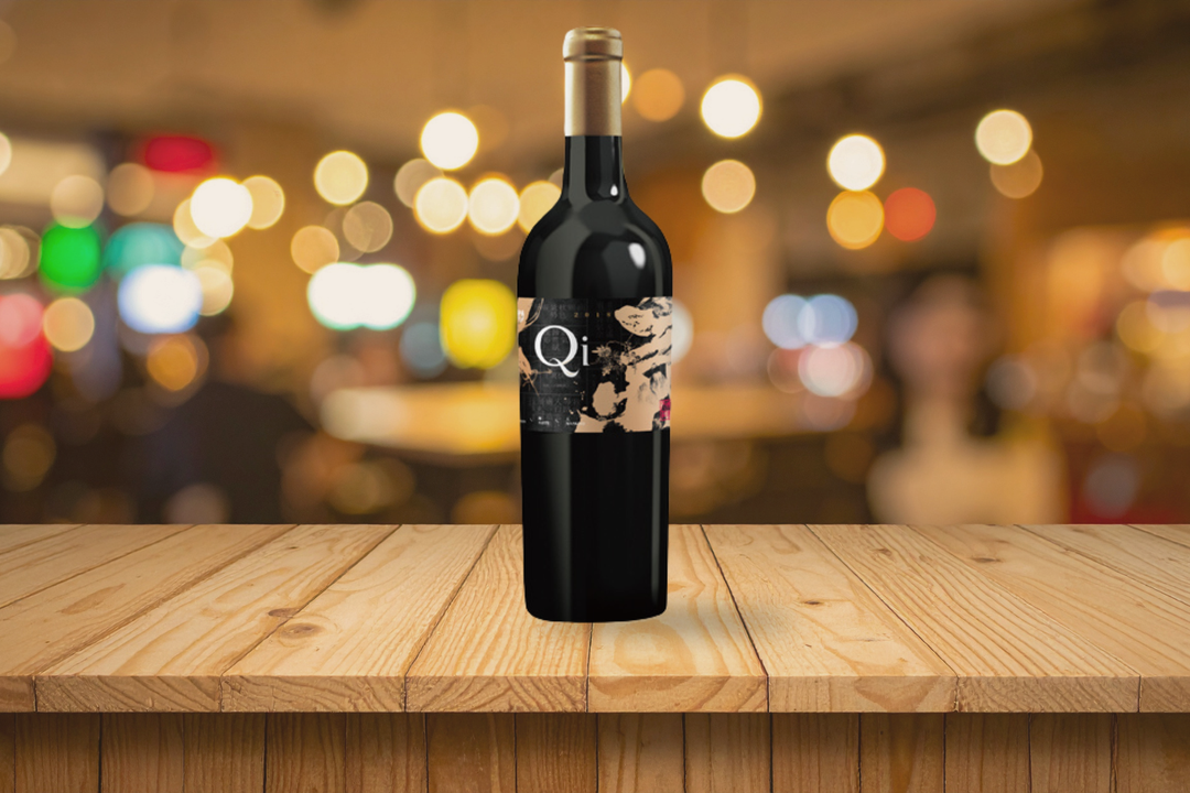Bottle of Qi Mankind Cabernet Sauvignon Syrah blend on a restaurant table during a wine tasting at ProWine Singapore 2026